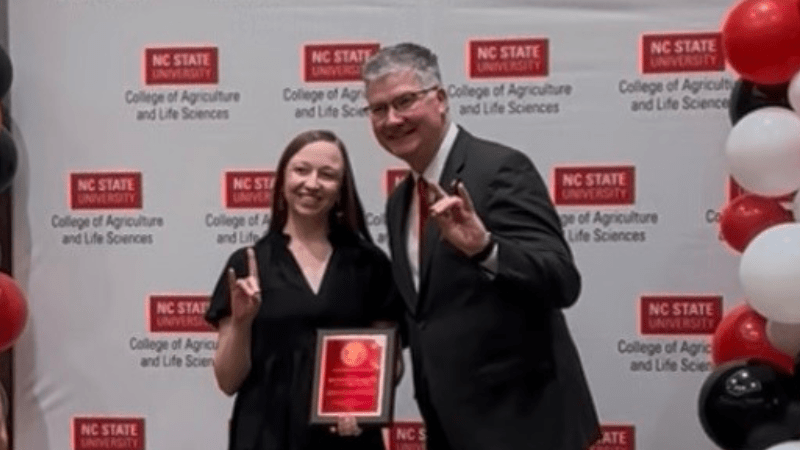 Jennifer Badger posing with award and CALS Dean