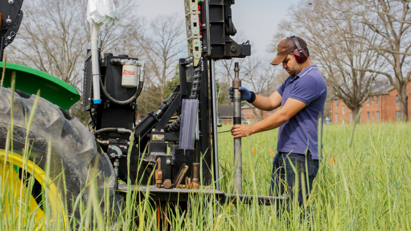 Person running a piece of agricultural research equipment