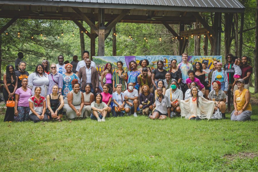 Group of artists and participants at the UPROOT open ceremony