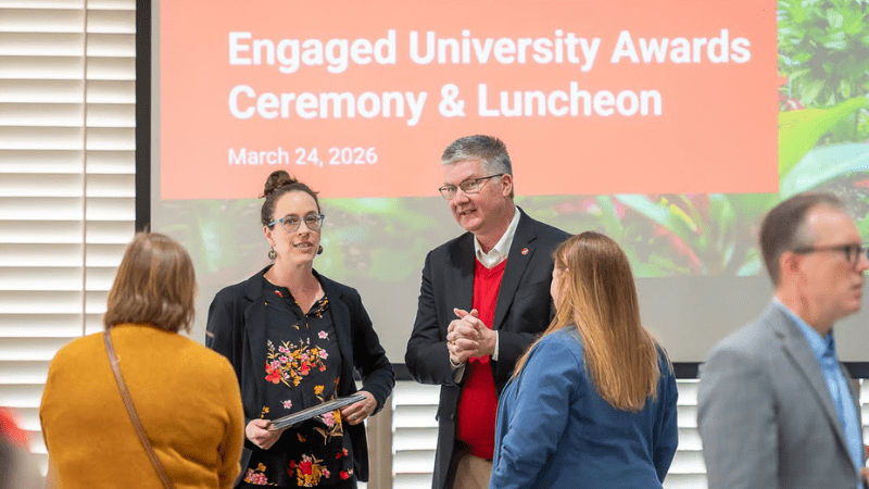 Dara Bloom with group at award ceremony