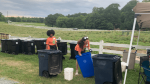 Volunteers sorting compost, recycling, and trash