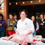 person showing audience large slab of meat