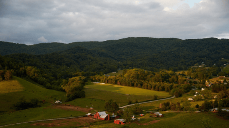 overhead view of farmland nestled in between mountains
