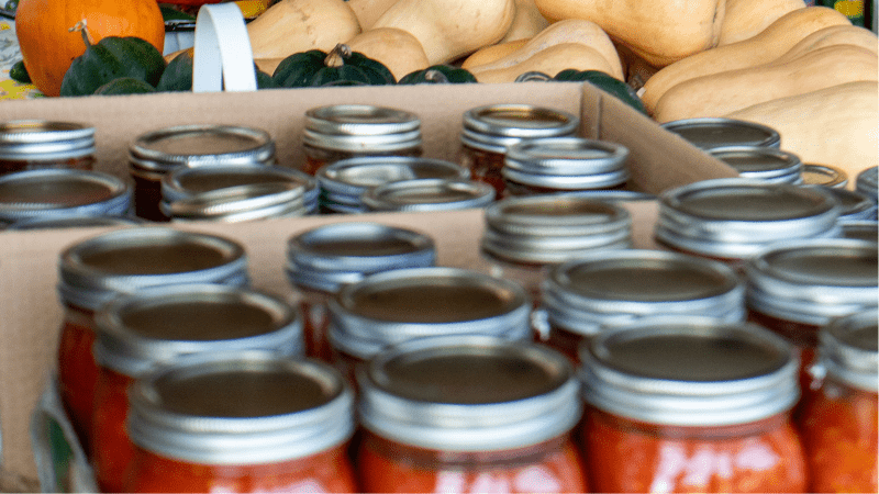 Pickling jars in box on table