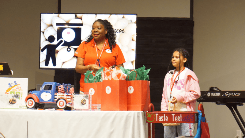 Shironda on Farm to ECE Institute with stage with student participant helping her present