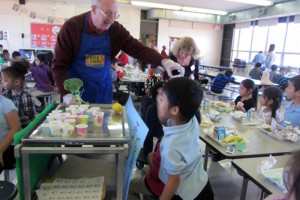 Extension Master Gardener volunteer Ken Meeks hands out broccoli samples at Oak Hill Elementary's cafeteria taste-test