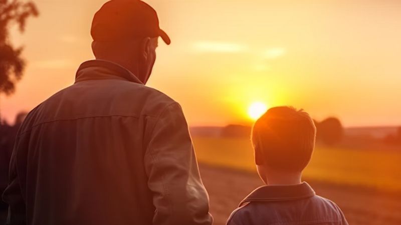 Father and son looking across a field